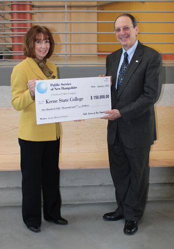 Bonnie Kurylo, PSNH Western/Central Division Manager, presents a rebate check to Interim President Jay Kahn