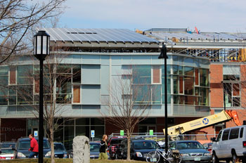 An array of solar panels is being installed on top of the new TDS building
