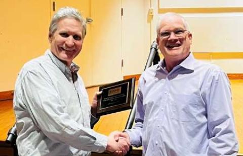 Christopher Fox ’93 holds his Music Department Distinguished Alumni Award plaque, presented by Joe Darby, music professor.