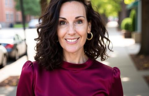 Dr. Erin Zaffini smiling on a sidewalk, wearing a maroon blouse.