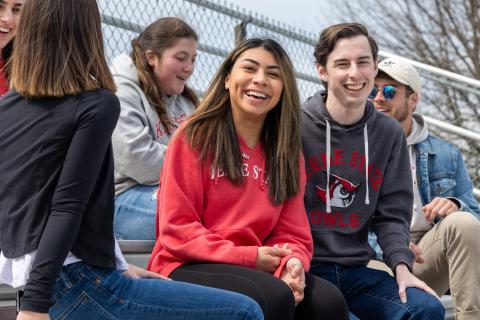 Students enjoy a game in the stands at Owl Athletic Complex