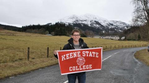 student with keene sign