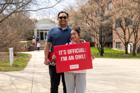 Admitted student and her father hold sign saying they chose Keene State