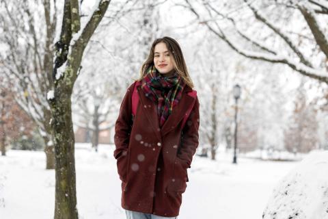Keene State student standing in the snow