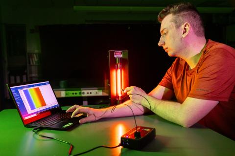 An optics student working in a lab