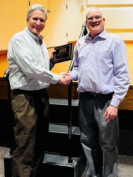 Christopher Fox ’93 holds his Music Department Distinguished Alumni Award plaque, presented by Joe Darby, music professor.
