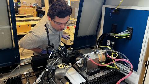 Alex Chabak inspects diamond turning equipment